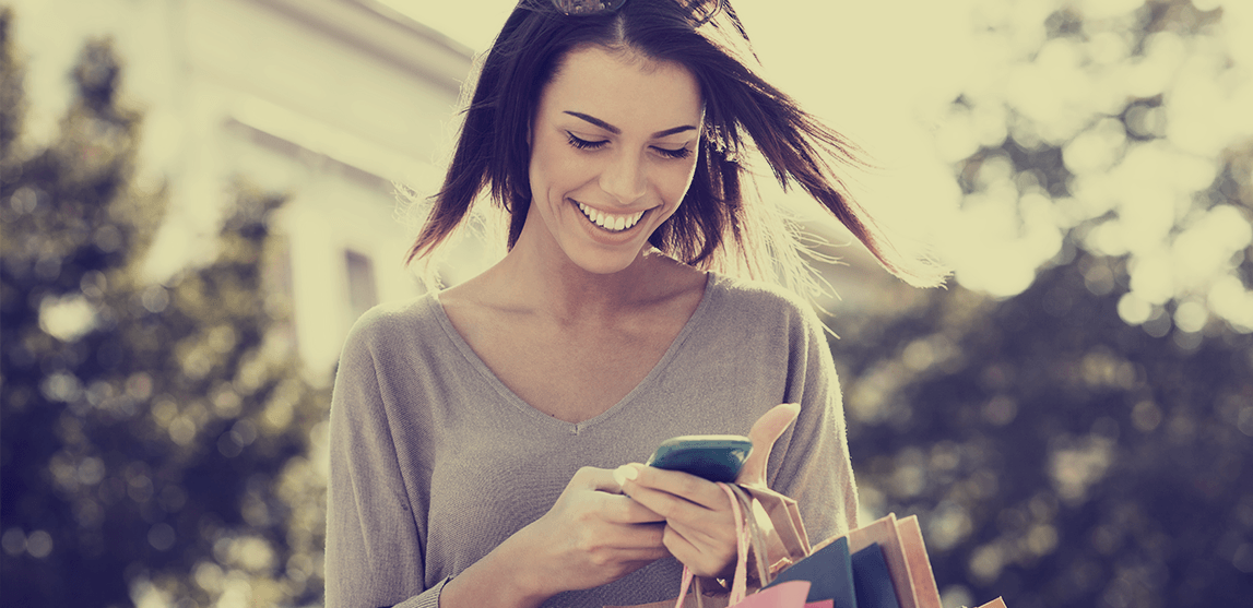 woman shopping while checking phone
