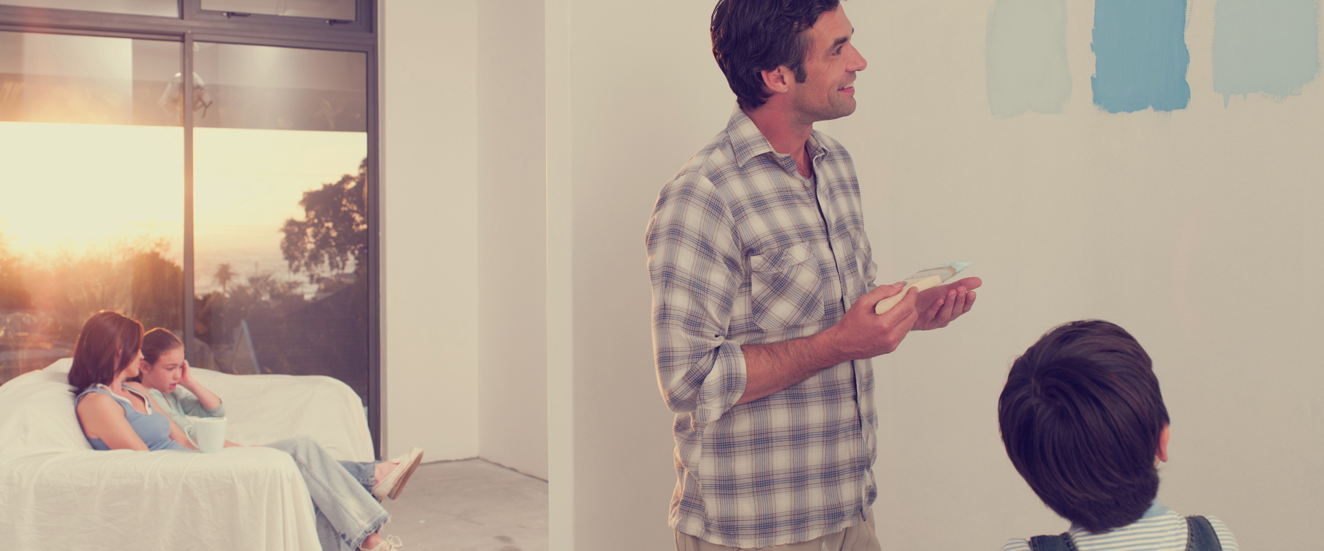 Man holding paintbrush while smiling