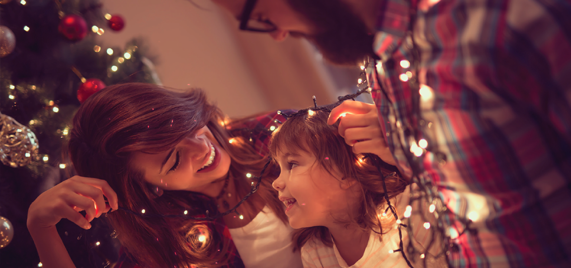 family decorating a christmas tree