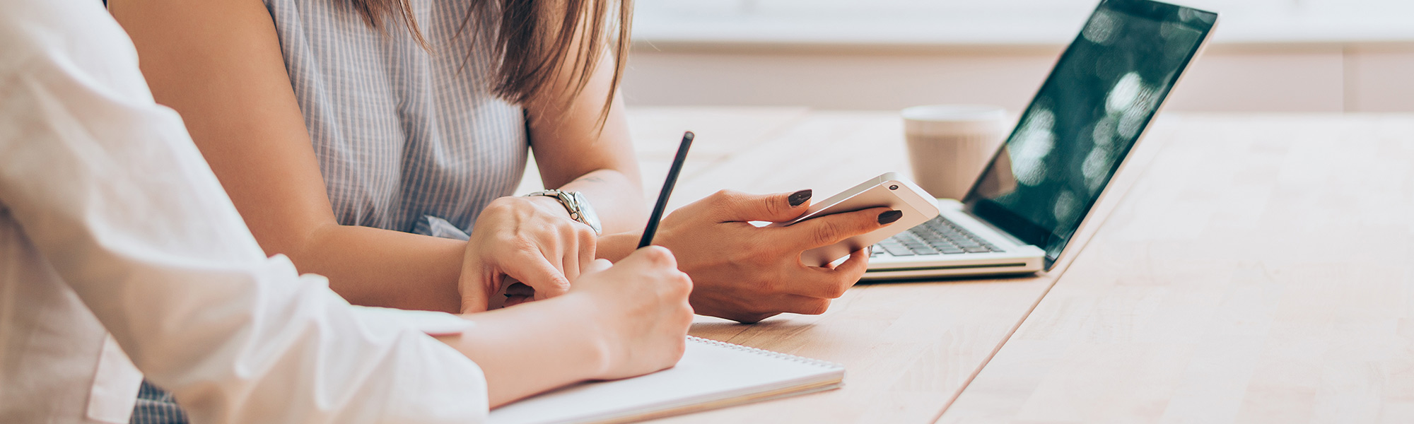 Person writing on notepad