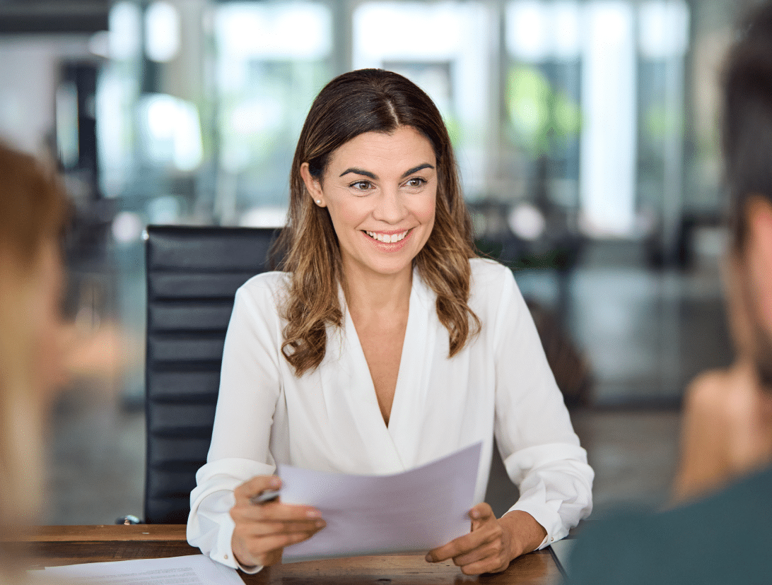 Lady holding paper smiling