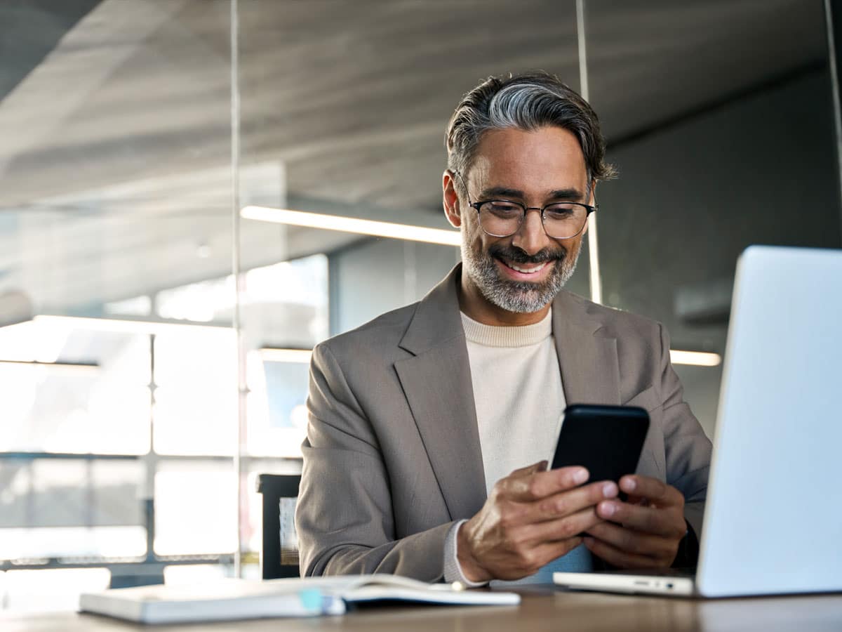 a man in a suit looking at a phone